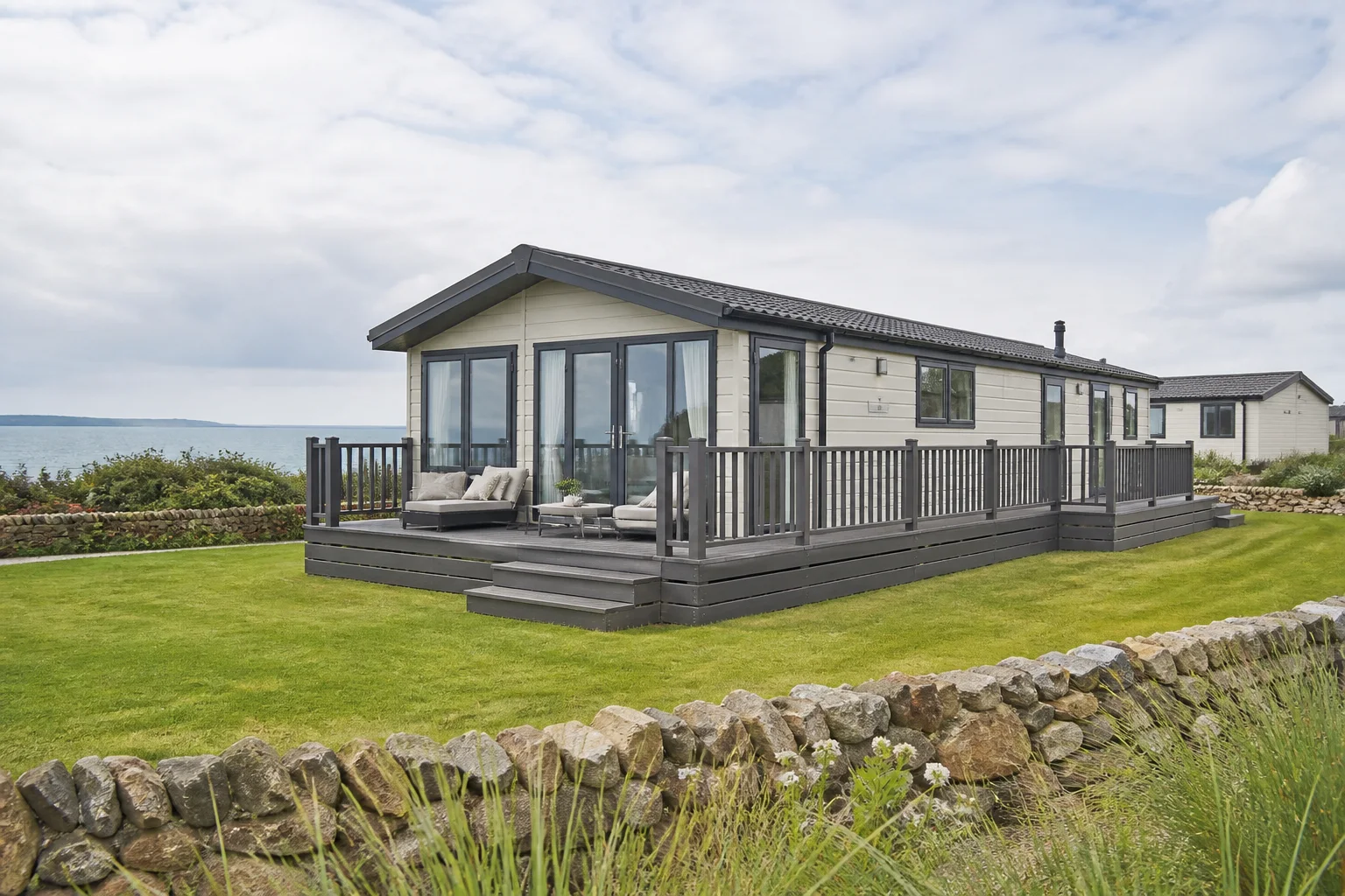Modern cream static caravan with decking near the sea